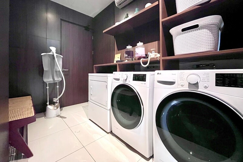 A clean, modern hotel laundry room with washing machines