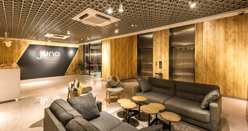 Modern hotel lobby with a reception desk and seating