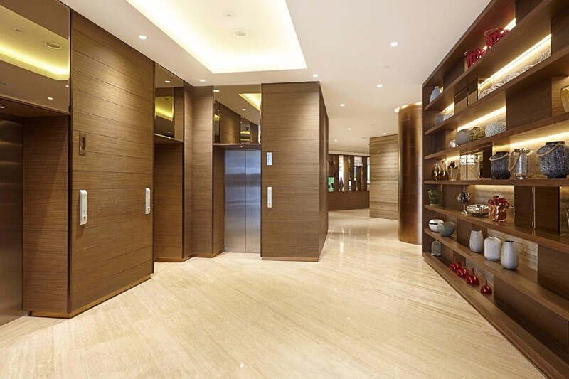 Modern hotel lobby with a reception desk and seating area