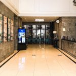 Modern hotel lobby with a reception desk and seating area