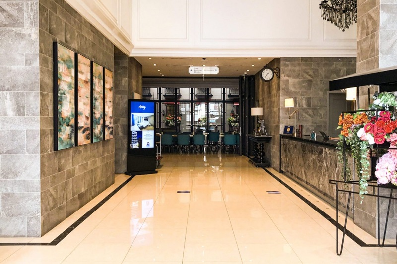 Modern hotel lobby with a reception desk and seating area