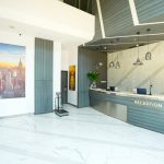 Modern hotel lobby with a reception desk and seating area