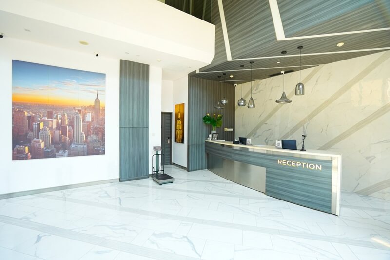 Modern hotel lobby with a reception desk and seating area
