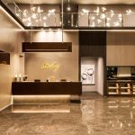 Modern hotel lobby area with a curved white sofa