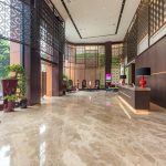 Modern hotel lobby area with a curved reception desk