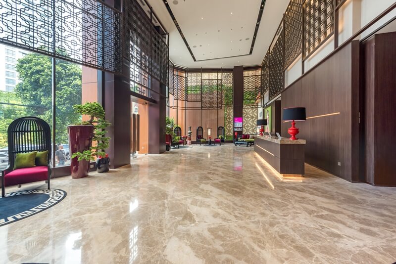 Modern hotel lobby area with a curved reception desk