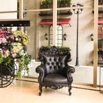 Ashley Hotel Group lobby corner with seating and a plant