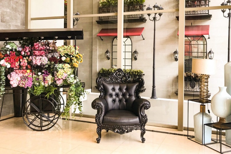 Ashley Hotel Group lobby corner with seating and a plant