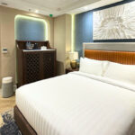 Modern superior queen hotel room with blue door