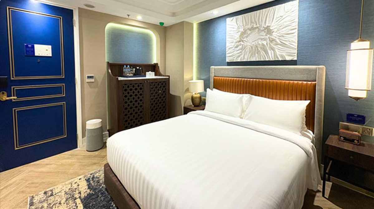 Modern superior queen hotel room with blue door