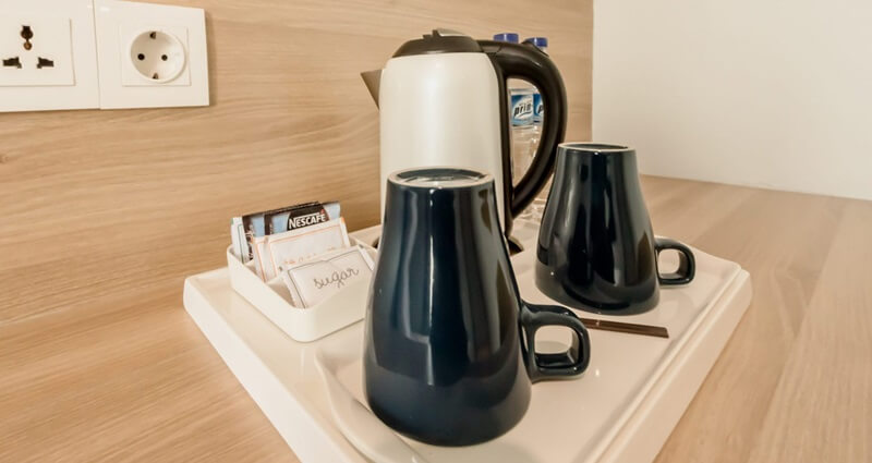 A white tray with various hotel room amenities