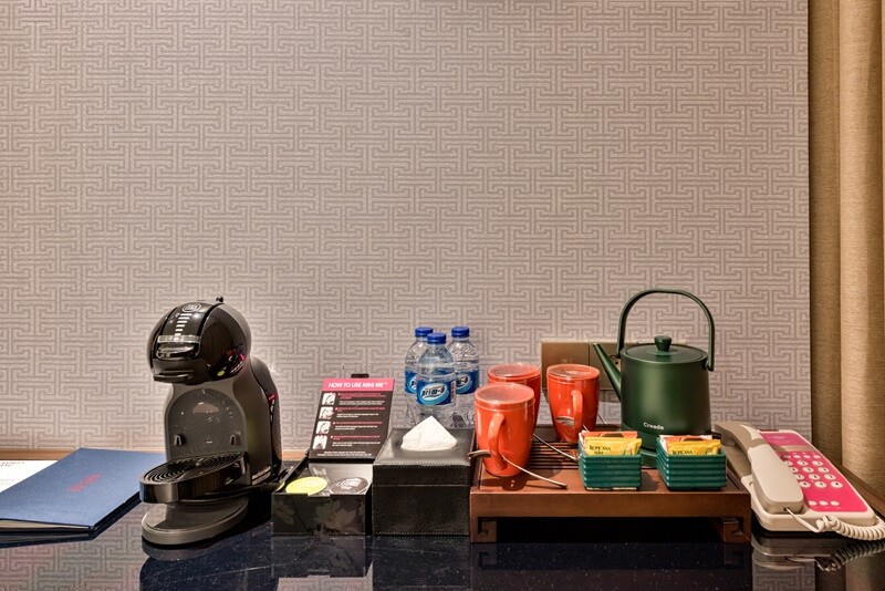 A set of hotel room amenities on a white tray