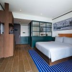A modern hotel bedroom, room 16