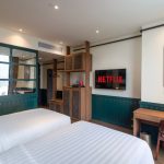 A modern hotel room with a neatly made bed