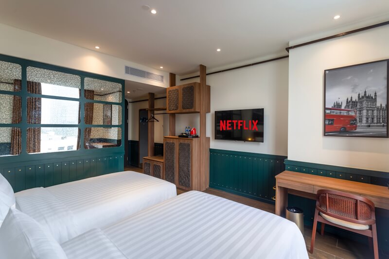 A modern hotel room with a neatly made bed