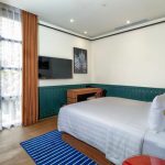 Modern hotel room4 with a bed and a city view