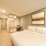 Modern hotel bedroom with a large window, room4-3