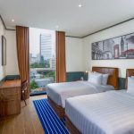 A modern hotel room 5 with a bed and large window