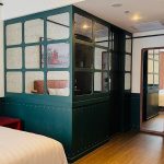 Modern hotel room 6 with a large bed and seating area
