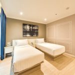 A minimalist hotel bedroom, room6, with a city view