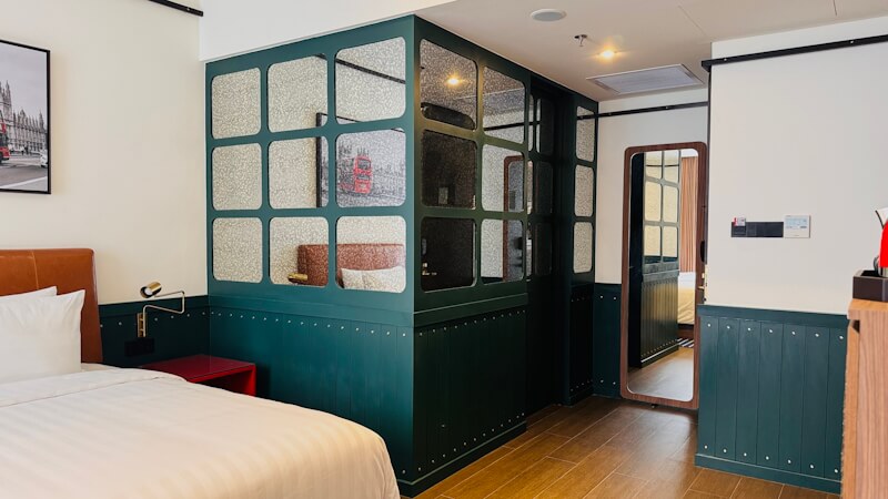Modern hotel room 6 with a large bed and seating area