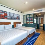 Modern hotel room 7 with a large bed and window