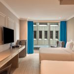 A modern hotel bedroom, room 7