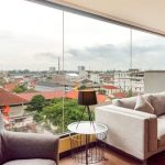 Modern hotel seating area with two gray armchairs