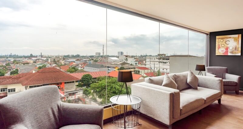 Modern hotel seating area with two gray armchairs