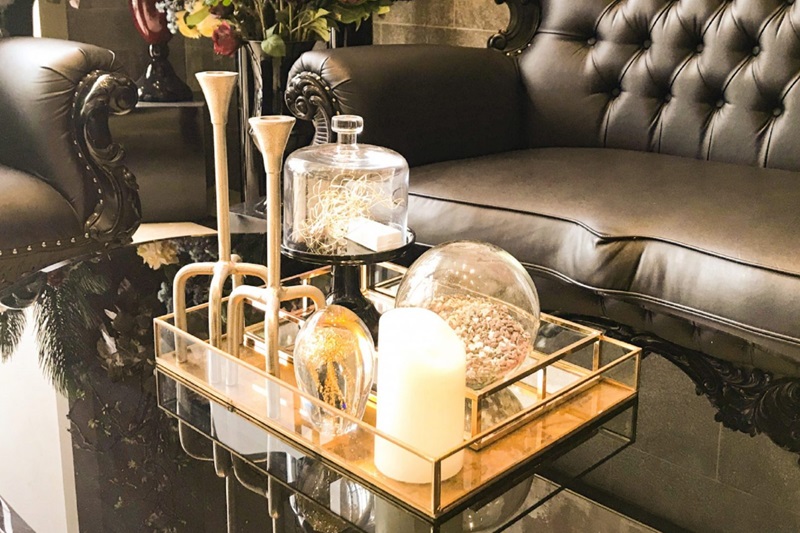 A modern hotel seating area with two grey armchairs