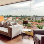 Modern hotel lobby seating area with a grey sofa