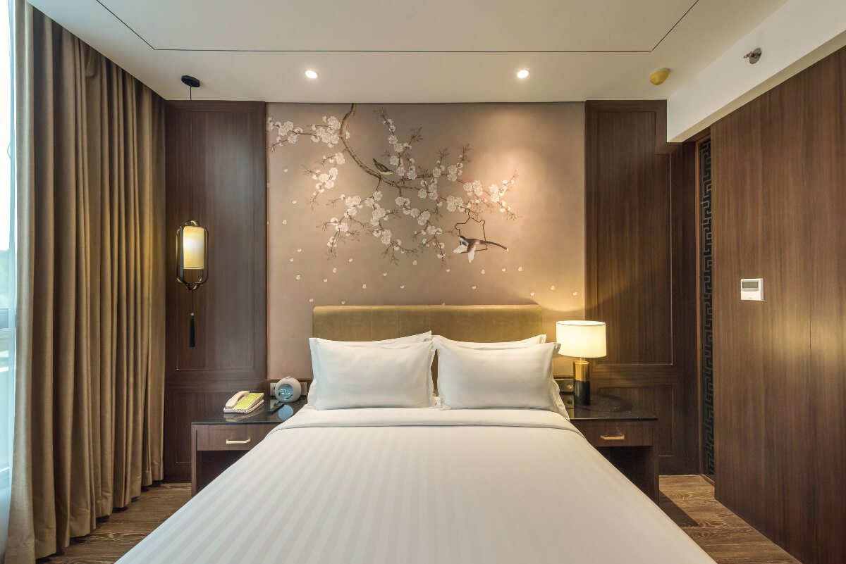 A modern superior hotel room with a large bed