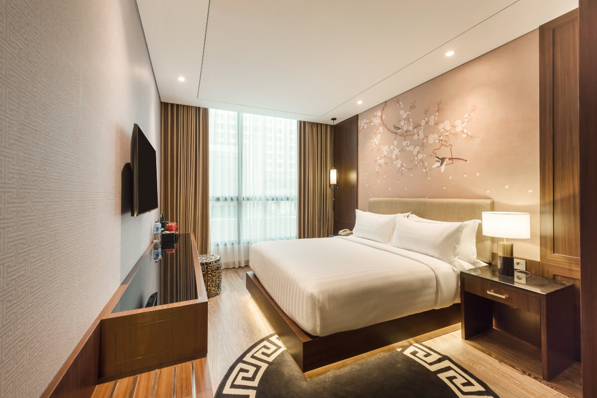 Modern superior hotel room with a queen bed