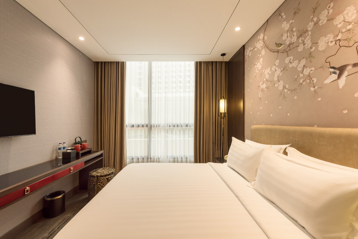 A modern superior hotel room with a queen bed and window