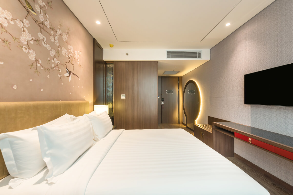 Modern superior hotel room with a large bed