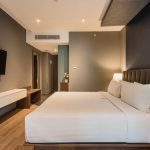 A bright Superior Double hotel room with a large bed