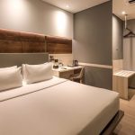 A modern Superior Double hotel room with a large white bed