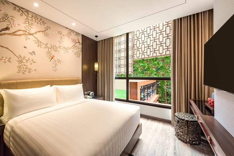 A modern superior double hotel room with two beds