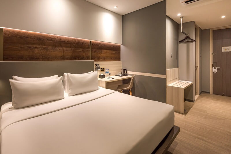 Superior double hotel room with a large white bed