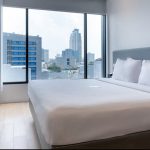A modern Superior Double hotel room with a white bed