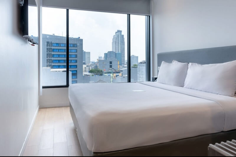 A modern Superior Double hotel room with a white bed