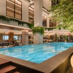 A modern hotel swimming pool with lounge chairs