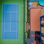 An empty outdoor tennis court with a net