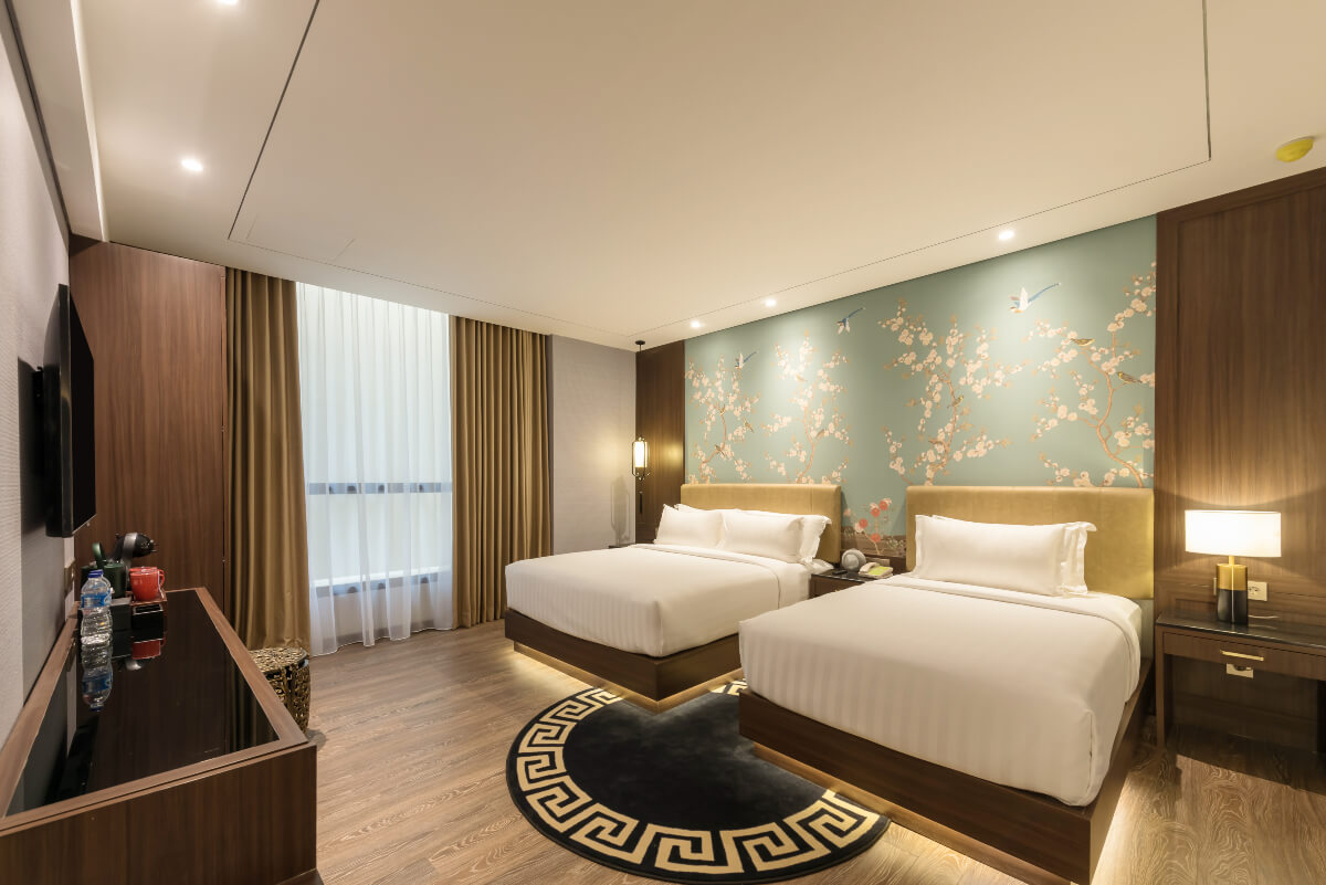 A modern hotel triple room with three beds