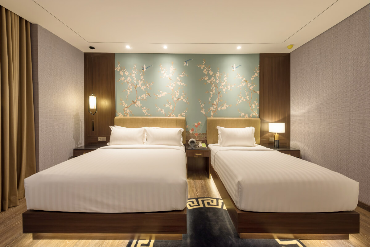 A modern triple hotel room with three single beds