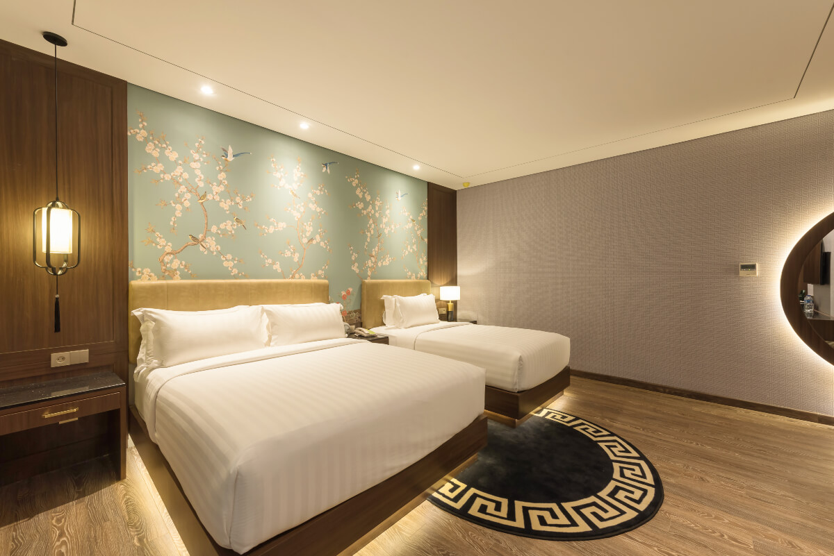 A modern triple hotel room with three single beds