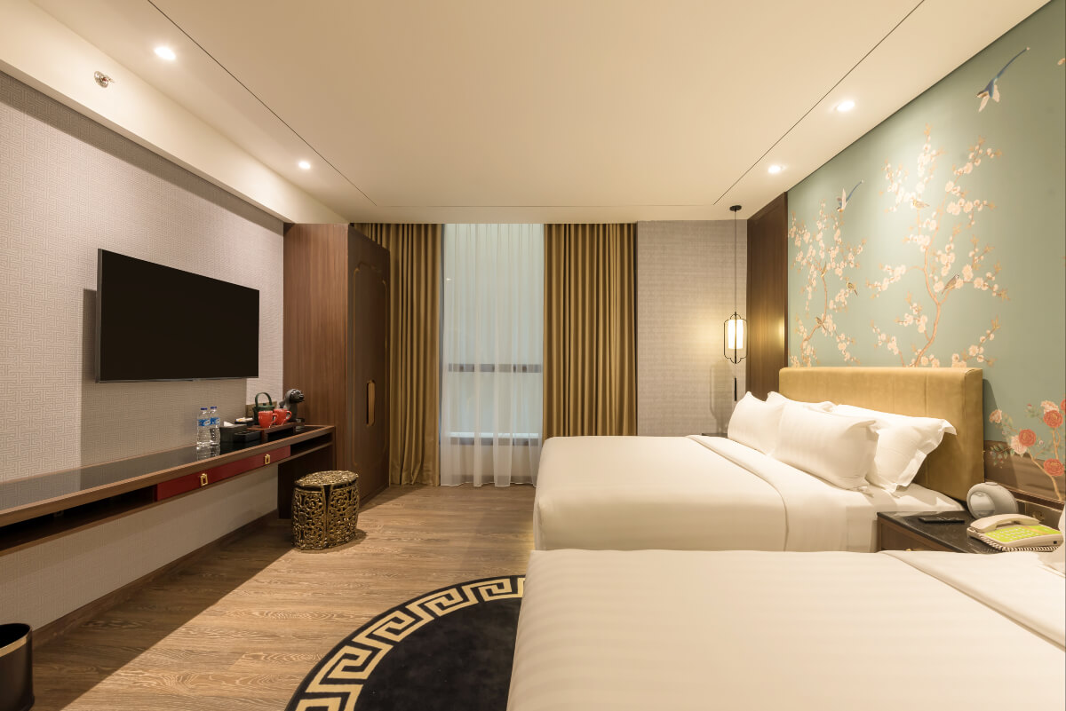 Modern triple hotel room with three single beds