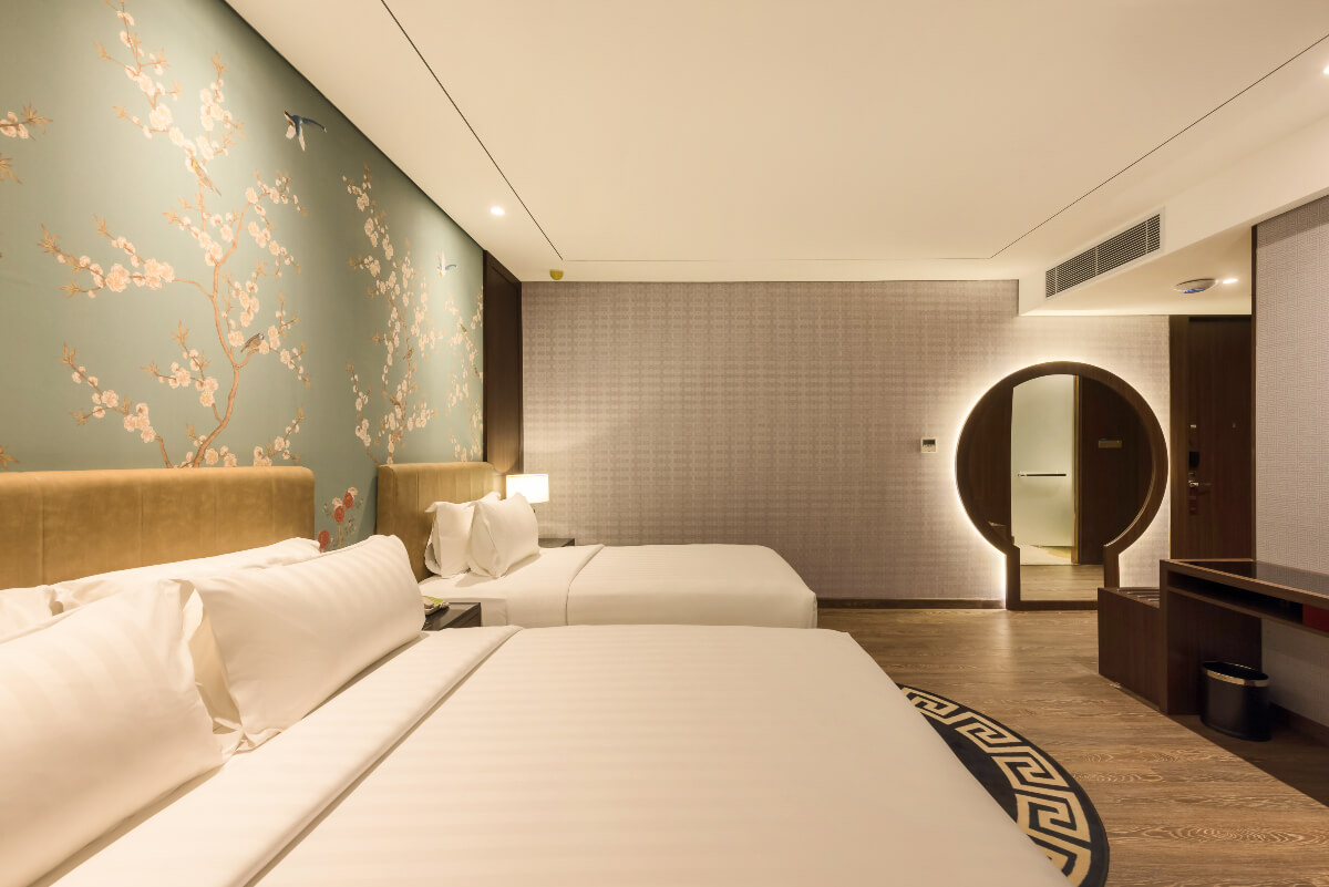 A modern triple hotel room with three single beds