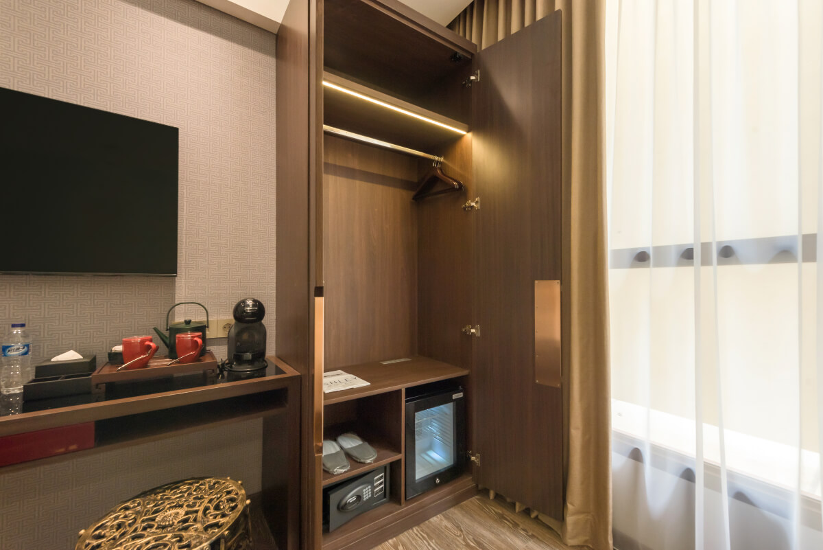 Modern triple hotel room with three single beds