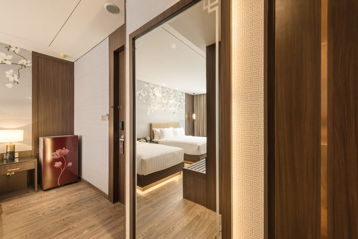 A modern triple hotel room with three single beds